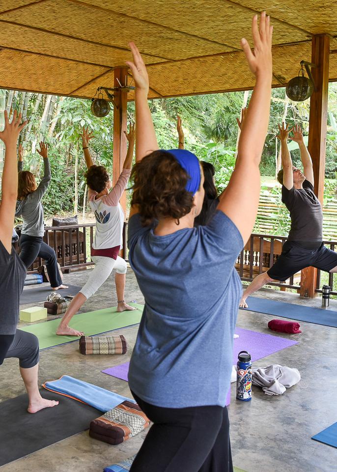 Warrior 1 at yoga retreat morning practice in Chiang Mai